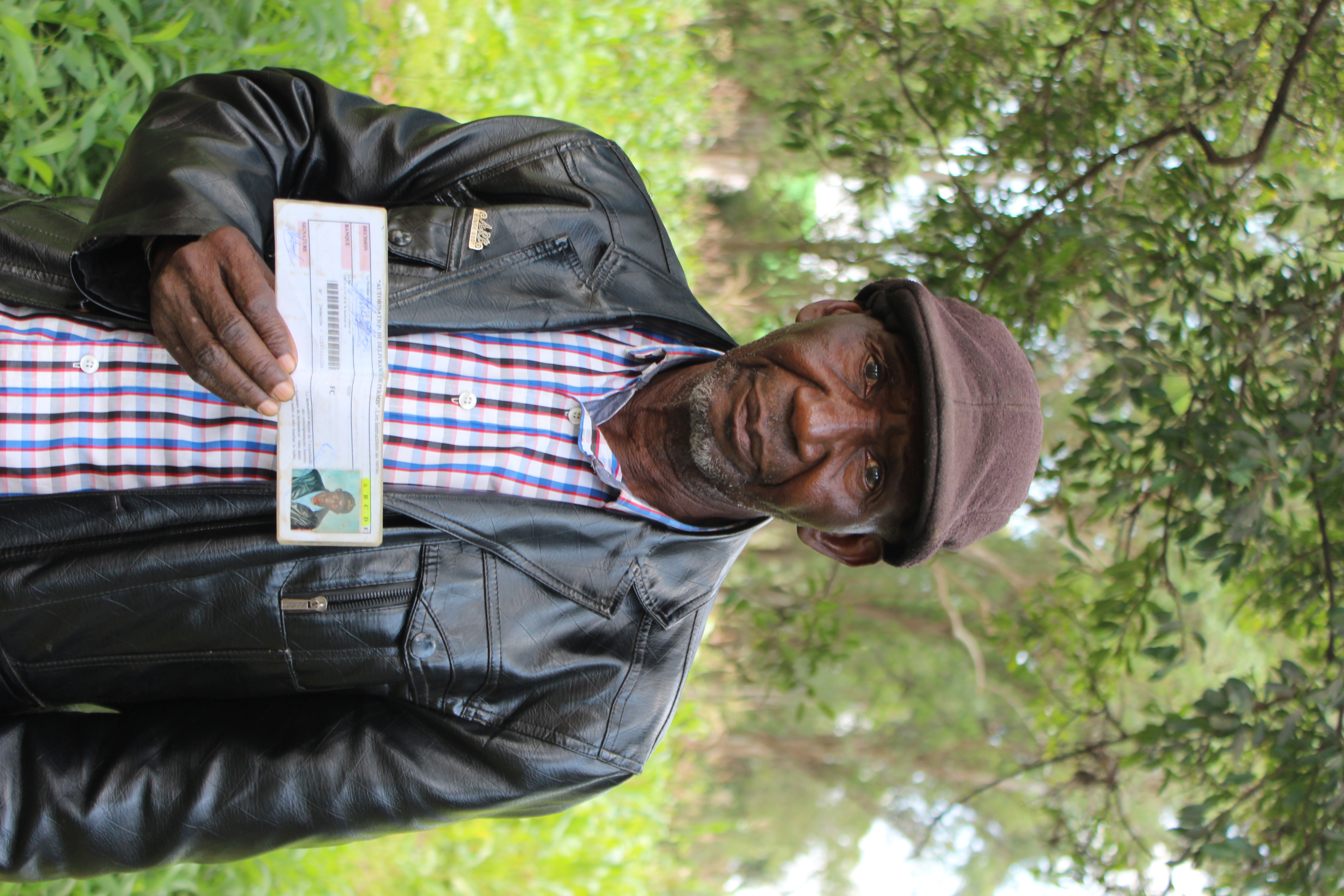 Tshibanda Lina, der Onkel von Eric Mutombo Kasuyi, zeigt den Fahrausweis seines verstorbenen Neffen.